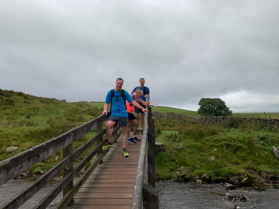 Yorkshire 3 Peaks Challenge striders on a bridge